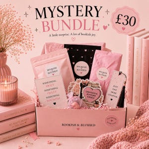 May include: A pink mystery bundle box labelled Bookish & Blushed containing various items including pouches, a card reading Something Spicy Something Sweet Something Bookish, a bookmark with Just One More Chapter, and a heart-shaped sticker.