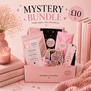 May include: A pink mystery bundle box labelled Bookish & Blushed containing various items including a bookmark with the text Just One More Chapter, a card reading Something Spicy Something Sweet Something Bookish, and a heart-shaped sticker.