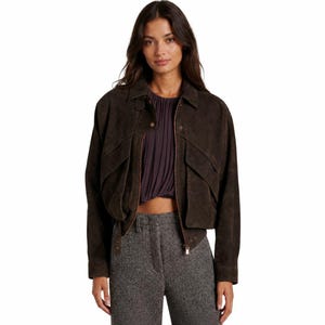 May include: A dark brown suede bomber jacket with a collared neckline, two front pockets, and a zipper closure. The jacket has a slightly cropped fit and is paired with gray tweed pants.