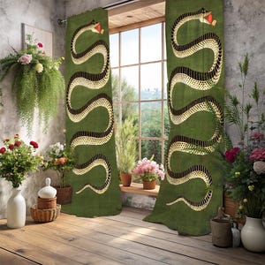 May include: Green curtains with a large snake design in black and gold. The snake has a red tongue. The curtains are hanging in front of a window with a view of trees. The room has a rustic, natural aesthetic with plants and flowers.