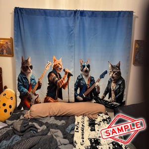 May include: Blue curtain featuring a band of four cats dressed in rock and roll attire. One cat sings into a microphone, while the others play guitar and keyboard. The cats are set against a gradient blue backdrop.