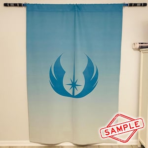 May include: A blue and white gradient curtain with a large blue emblem featuring a starburst design. The curtain is hanging from a black rod. The word "SAMPLE" is stamped in a red diamond shape in the lower right corner.