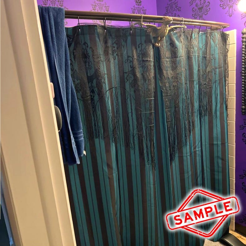 May include: A teal and black striped shower curtain with a dark pattern and fringe detail. A blue towel hangs on the left. A decorative bird is attached to the shower rod. The word "SAMPLE" is in a red and white stamp.