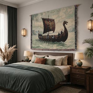 May include: A rectangular woven wall tapestry featuring a dark Viking longship sailing on choppy water. The ship has a black sail with a gold eagle emblem and a dragon-shaped prow. The edges of the tapestry have a decorative fringe border.