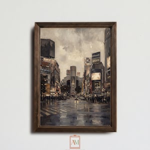 May include: A framed print depicting a Japanese street scene, with buildings, signs, and people. The artwork uses a muted colour palette, highlighting the wet street and reflections. The print is set in a dark brown frame.