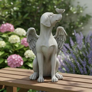 May include: A grey stone statue of a dog with angel wings, seated on a wooden bench. A butterfly rests on the dog's nose. The statue is surrounded by pink and white hydrangeas and purple lavender.