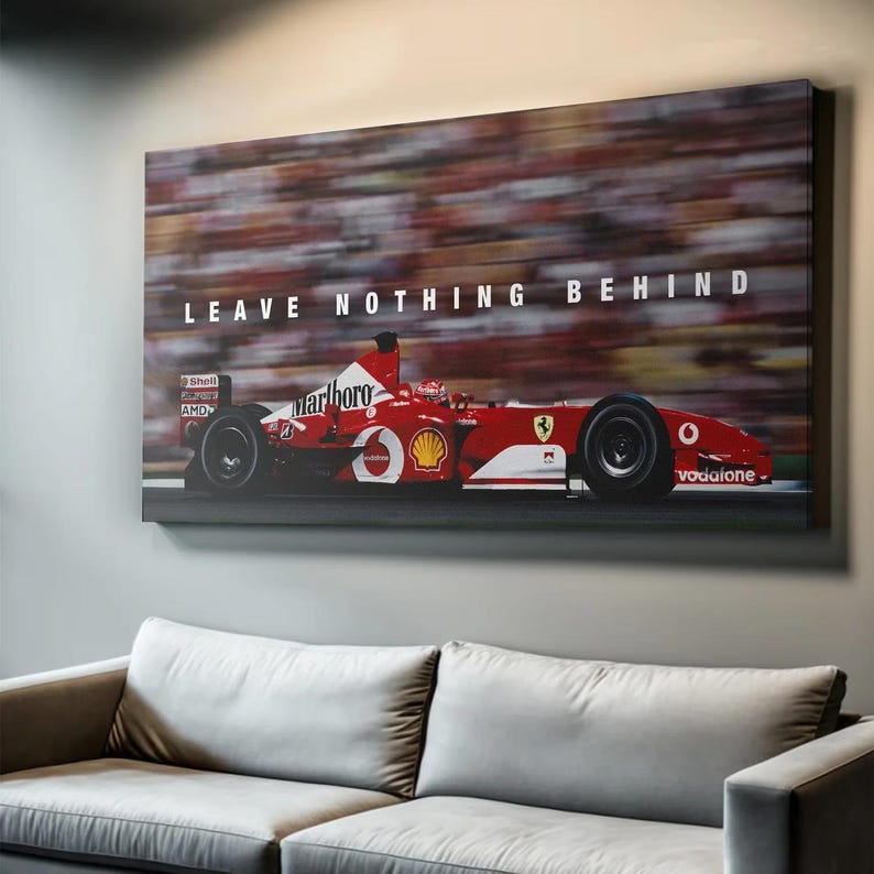 May include: A rectangular canvas wall art print featuring a red Formula One race car with white Marlboro and Shell branding. The car is captured in motion against a blurred grandstand background with the text LEAVE NOTHING BEHIND in white.