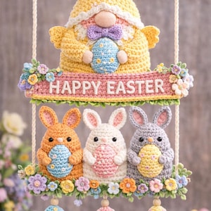 May include: Crocheted Easter decoration featuring a gnome and three bunnies holding eggs, with the text "HAPPY EASTER". The decoration is suspended from a wooden dowel with a rope. The bunnies are orange, white, and gray, each holding a colorful egg.