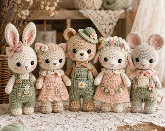May include: A collection of five handmade crochet animal dolls: a bunny, cat, bear, lamb, and mouse. Each doll is dressed in pastel-colored outfits with floral accents. The dolls are arranged on a white lace surface, with yarn and dried flowers in the background.