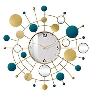May include: A decorative wall clock with a gold-colored metal frame. The clock face is white with gold hands and black numerals. The design includes teal, gold, and mirrored accents in a circular pattern.