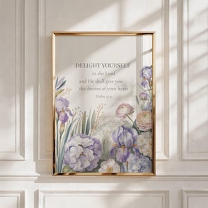 May include: A framed print with a gold border features the text "DELIGHT YOURSELF in the Lord and He shall give you the desires of your heart Psalm 37:4." The print is decorated with watercolor flowers in shades of purple, white, and pink.