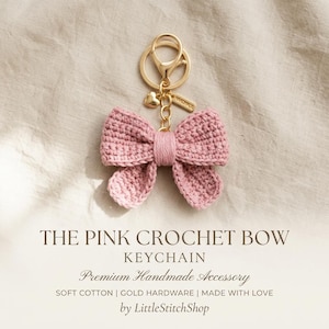 May include: A pink crocheted bow keychain with gold-colored hardware. The bow is made of soft cotton and features a heart charm. The text "THE PINK CROCHET BOW KEYCHAIN" is displayed below the keychain.
