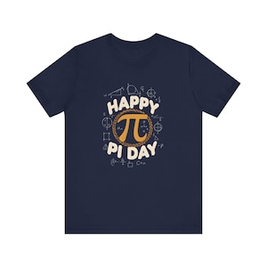 May include: Navy blue t-shirt with a graphic celebrating Pi Day. The design features the Greek letter pi, surrounded by a wreath and the words "Happy Pi Day". Mathematical symbols and equations are also included.