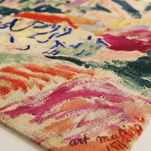 May include: Close-up of a textured, square artwork with vibrant brushstrokes in shades of red, pink, blue, green, and yellow. The artwork has the text "art mai" in the bottom right corner.