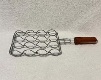 Comparativa de soportes portátiles para mazorcas de maíz para barbacoa con capacidad para 4 mazorcas.