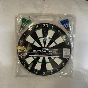 May include: A new dartboard game set in a clear plastic package. The dartboard is black and white with green and white accents, and includes green and blue darts. The packaging includes the text "DARTBOARD GAME".