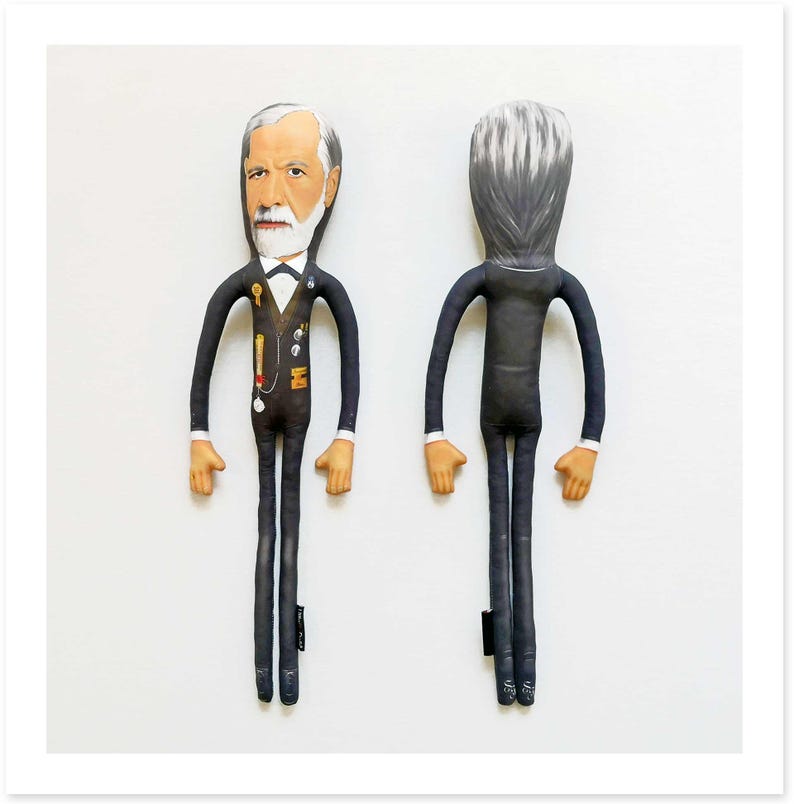 May include: Two fabric dolls, one facing forward and one facing backward, both dressed in black suits. The front-facing doll has a detailed face with a white beard and hair, and a bow tie. The doll has long arms and legs, and tan hands and feet.