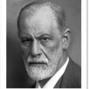 May include: Black and white portrait of a man with a white beard and a serious expression. He is wearing a suit and tie. The image is a close-up of his face.