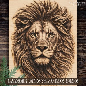 May include: A detailed laser engraving of a lion's head on a wooden surface. The artwork features intricate details of the lion's mane and facial features. The text "LASER ENGRAVING PNG" is at the bottom.