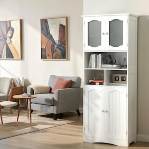 May include: A tall white storage cabinet featuring two upper doors with arched glass panels, an open middle shelf section, and two lower doors with vertical panel detailing. The cabinet includes small round silver knobs on all four doors.