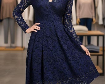 May include: A navy blue lace dress with long sleeves and a scalloped V-neck. The dress has a fitted bodice and a flared skirt, creating an elegant silhouette. The intricate floral lace pattern adds a touch of sophistication to this formal wear.