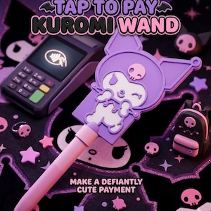May include: A purple and light pink Kuromi wand featuring a character graphic with a skull icon, positioned next to a payment terminal. The text reads TAP TO PAY KUROMI WAND and MAKE A DEFIANTLY CUTE PAYMENT. The wand has a long handle and a flat top.