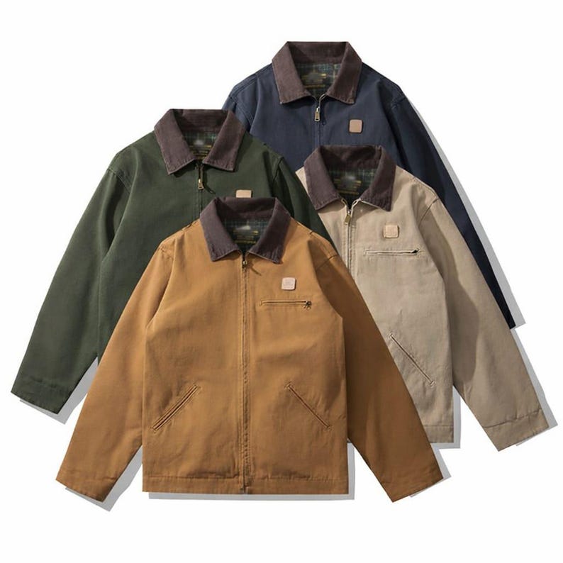 May include: Four work jackets in various colors: brown, green, navy, and tan. Each jacket has a brown collar, a small square patch, a zipper closure, and two front pockets. The jackets are made of a durable material.