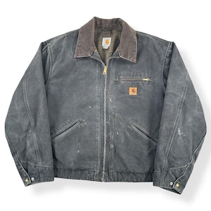 May include: A charcoal-colored work jacket with a brown corduroy collar. The jacket features a full zipper, multiple pockets, and a small logo patch. The jacket has a worn appearance, suggesting it is pre-owned.