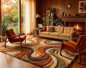 May include: A retro-style living room with a large, colorful area rug featuring a wavy pattern in shades of brown, orange, and green. The room includes a mustard-colored sofa, two orange armchairs, and a fireplace. A large window offers a view of the outdoors.