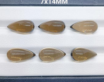 Könnte beinhalten: Sechs durchscheinende, braune, tropfenförmige Edelsteine, angeordnet in zwei Reihen zu je drei Stück. Jeder Stein misst 7x14mm, wie durch den Text oben angegeben. Die Steine haben eine glatte, polierte Oberfläche mit sichtbaren Lichtreflexen.
