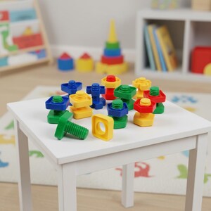 May include: A collection of colorful plastic toy bolts and nuts in red, yellow, green, and blue. The toys are arranged on a small white table. A green bolt is lying on its side. Other toys are visible in the background.