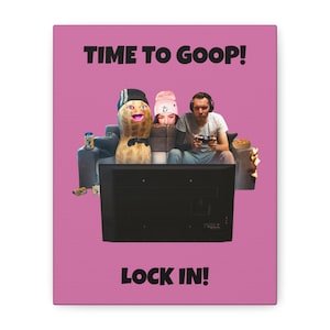 Puede incluir: Una impresión en lienzo rosa con el texto "TIME TO GOOP!" en la parte superior y "LOCK IN!" en la parte inferior. La imagen presenta un cacahuete de dibujos animados, dos personas y un televisor, lo que sugiere un tema de juego.