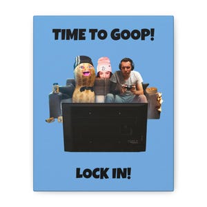 Puede incluir: Impresión en lienzo con fondo azul claro con el texto "TIME TO GOOP!" arriba y "LOCK IN!" abajo. La imagen representa a una persona jugando a un videojuego, un personaje de cacahuete y una persona con un gorro rosa.