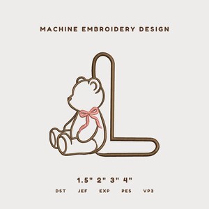 May include: A machine embroidery design featuring a brown outline of the letter L paired with a brown outline of a seated teddy bear wearing a pink bow. The text reads MACHINE EMBROIDERY DESIGN and 1.5" 2" 3" 4" with file formats DST, JEF, EXP, PES, VP3.
