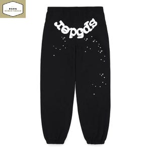 May include: Black sweatpants with the word "spider" in white, stylized text across the upper back. White star-shaped accents are scattered down the right leg. The Eden Streetwear logo is in the upper left corner.