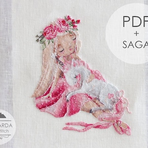 May include: A cross-stitch pattern on white fabric featuring a girl with long hair and a floral crown holding a small white unicorn. The design includes pink and red accents, with text reading PDF + SAGA and MANSARDA cross stitch visible.