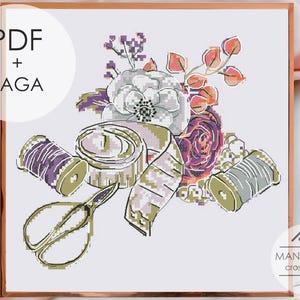 May include: A cross stitch pattern featuring a floral arrangement with a large white flower, purple and orange leaves, a measuring tape, a pair of scissors, and two spools of thread in purple and gray. The image includes the text PDF + SAGA.