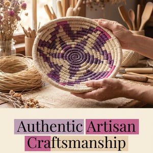 May include: A round, shallow, handwoven basket featuring a coiled design with alternating natural beige, deep purple, and magenta fibre patterns. The text below reads: Authentic Artisan Craftsmanship, HANDWOVEN WITH NATURAL FIBRES.