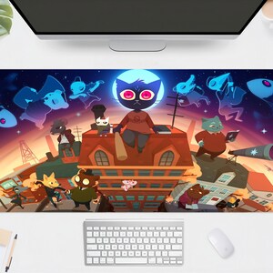 May include: A rectangular mouse mat with a vibrant cartoon illustration of animal characters on rooftops under a starry night sky. The design includes a large cat character with red eyes, a telescope, and other whimsical elements.