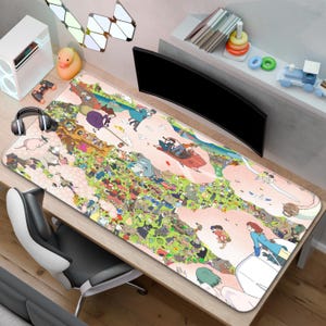 May include: A large rectangular desk mat with a colourful illustration of anime characters. The mat is mainly pink and green, with a detailed design. The mat is on a wooden desk, with a computer monitor and other accessories visible.