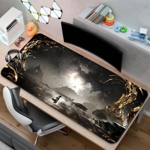 May include: A large rectangular gaming mouse mat with a detailed fantasy landscape design in shades of black, grey, and gold. The mat features a central figure and a curved monitor is visible in the background.