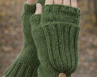 May include: Green knitted fingerless gloves with a button detail. The gloves are a solid green color and have a ribbed cuff and a flap that covers the fingers. The gloves are made of a soft, warm material.