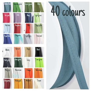 May include: An image showcasing 40 colours of fabric trim, such as denim blue, emerald green, and hot pink. The text "40 colours" is displayed in black. A close-up shows a roll of blue trim.