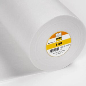 May include: A roll of white fabric with a yellow and orange label. The label reads "S 80" and includes text and a barcode. The roll is 50 cm x 22 m.