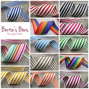 May include: A selection of striped ribbons in a variety of colours, including blue, red, black, pink, green, and rainbow. The ribbons are arranged in a grid, each showcasing a different colour combination. The text "Bertie's Bows" is visible.