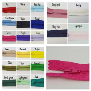 May include: A collection of zippers in various colors, including red, white, pale blue, dusky pink, ivory, cornflower, black, royal, navy blue, light pink, cerise, purple, lilac, fawn, mustard, yellow, olive, sage, emerald, bottle green, light green, and jade.