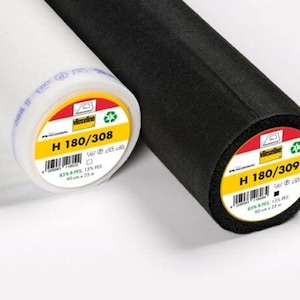 May include: Two rolls of fabric, one white and one black, are displayed. The white roll has a yellow and red label with the text "H 180/308" and "90 cm x 25 m". The black roll has a similar label with "H 180/309".
