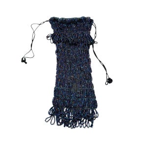 May include: A drawstring pouch covered in iridescent dark blue and purple beads. The bag features a gathered top, a rectangular body with horizontal rows of beadwork, and a fringe of beaded loops hanging from the bottom edge with thin black cords.