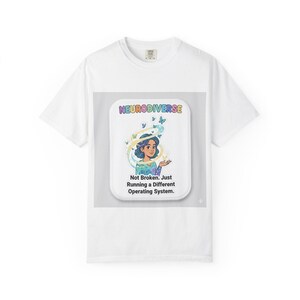 May include: White t-shirt featuring a graphic with the word "NEURODIVERSE" in rainbow colors. The graphic includes an illustration of a person with butterflies and the text "Not Broken, Just Running a Different Operating System."