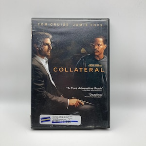 May include: A DVD case for the movie "Collateral" featuring Tom Cruise and Jamie Foxx. The cover has a dark, moody aesthetic with the title in large, bold letters. Quotes from critics are also visible.